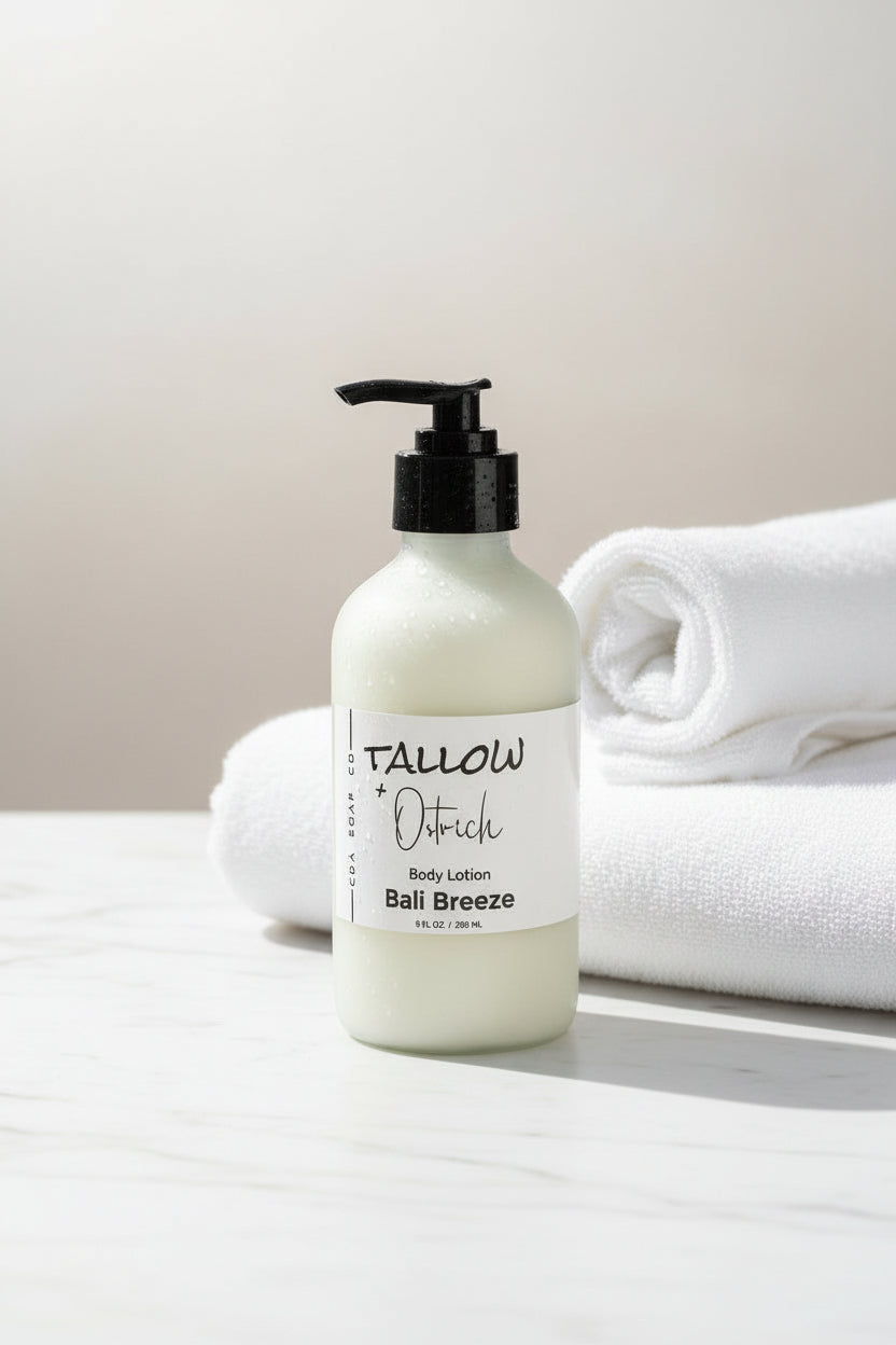Bottle of Bali Breeze scented Tallow & Ostrich oil body lotion with white towels