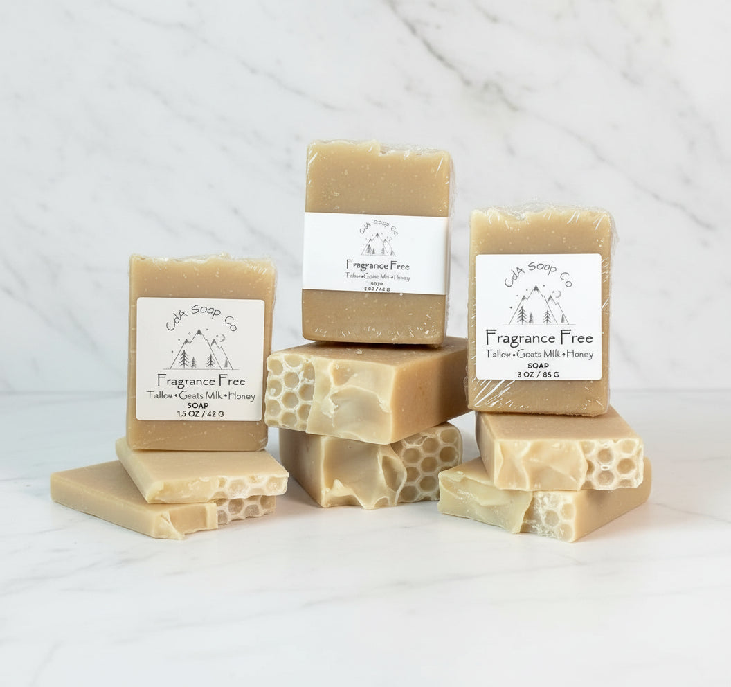 Collection of soap bars with 'Fragrance Free' labels on a marble surface.