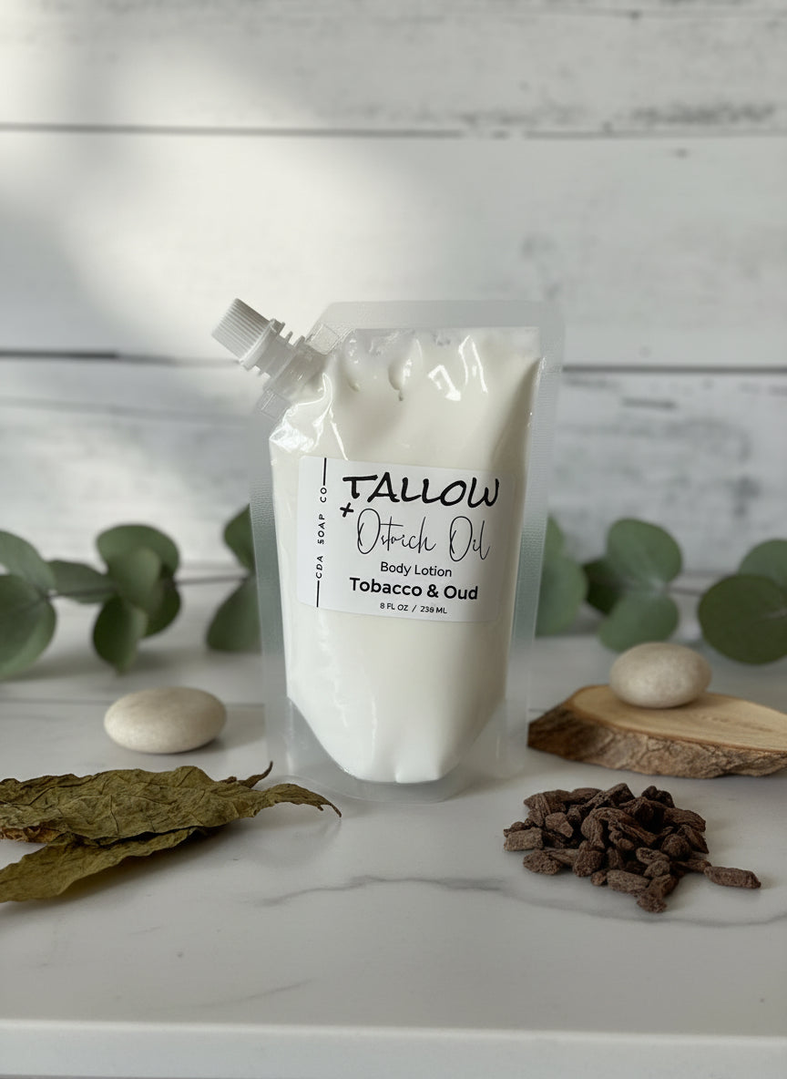 Tobacco & Oud body lotion with natural elements on a marble surface