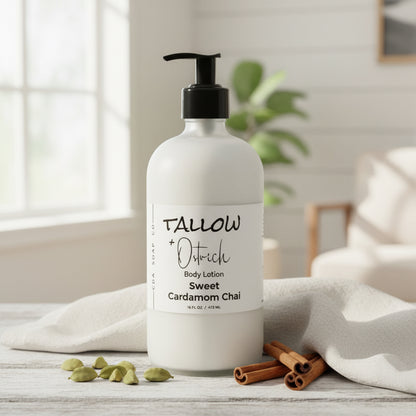 Body lotion bottle with 'Tallow + Ostrich' branding on a wooden surface with cinnamon sticks and cardamom pods.