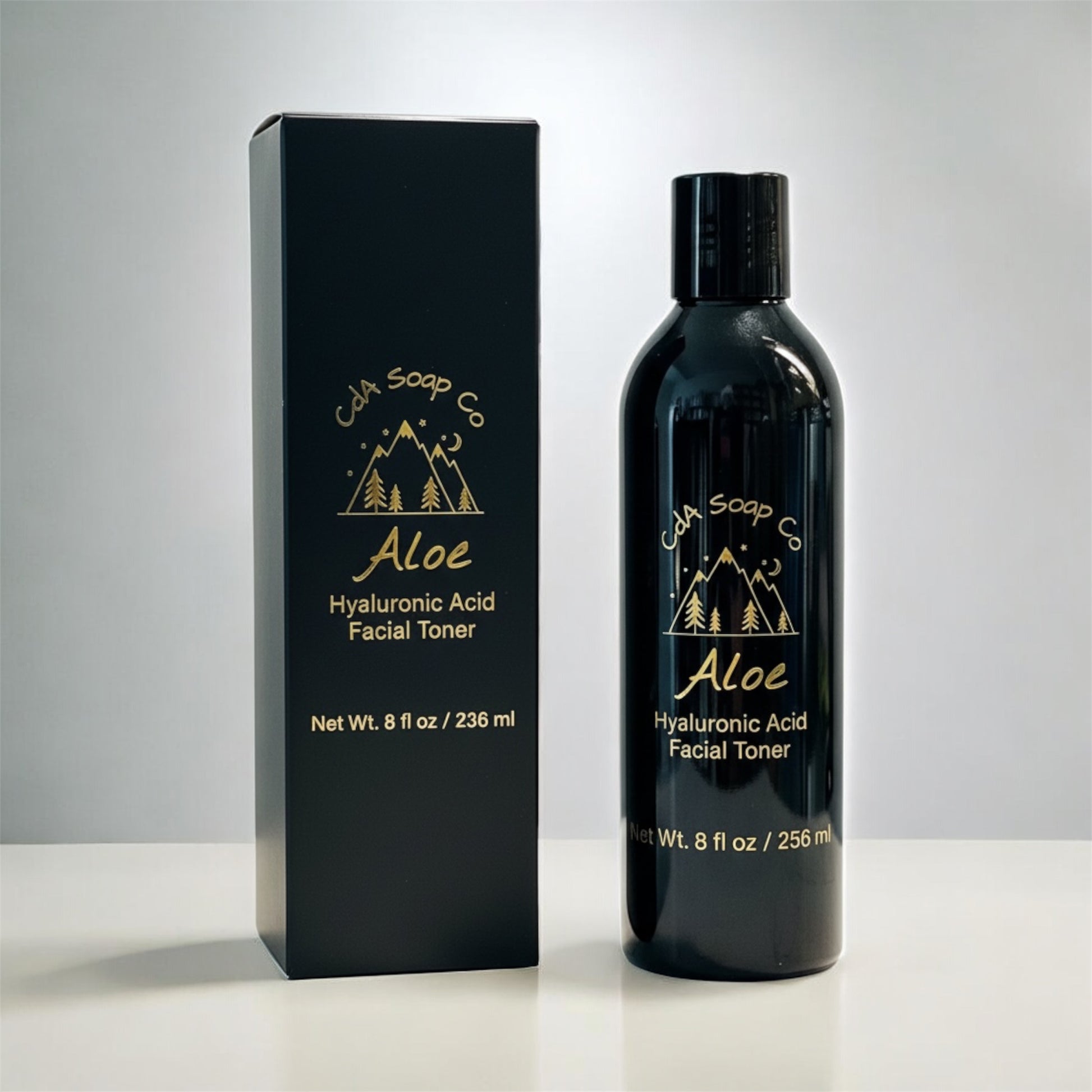 Black bottle and packaging of Cda Soap Co Aloe Hyaluronic Acid Facial Toner on a white background