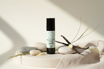 Black lip balm with white label. Vanilla beans with stones and cloth accessory decor 