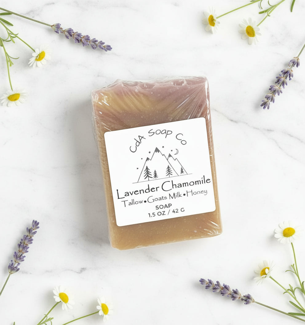 Bar of soap with a label surrounded by lavender and flowers on a white background