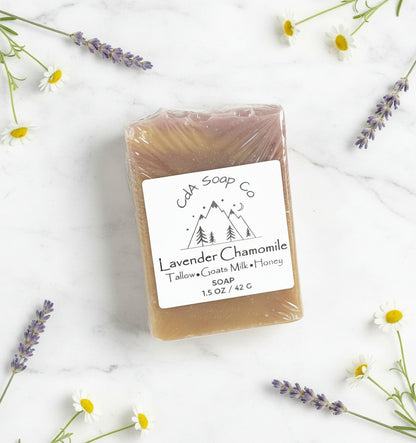 Bar of soap with a label surrounded by lavender and flowers on a white background