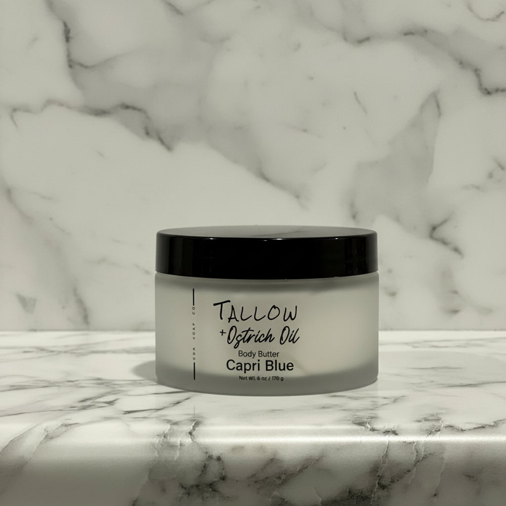 Jar of Tallow + Ostrich Oil Body Butter on a marble surface with a marble background