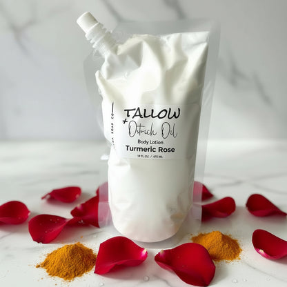 White body lotion pouch with 'Tallow & Oatrich Oil' branding on a marble surface with turmeric and rose petals.