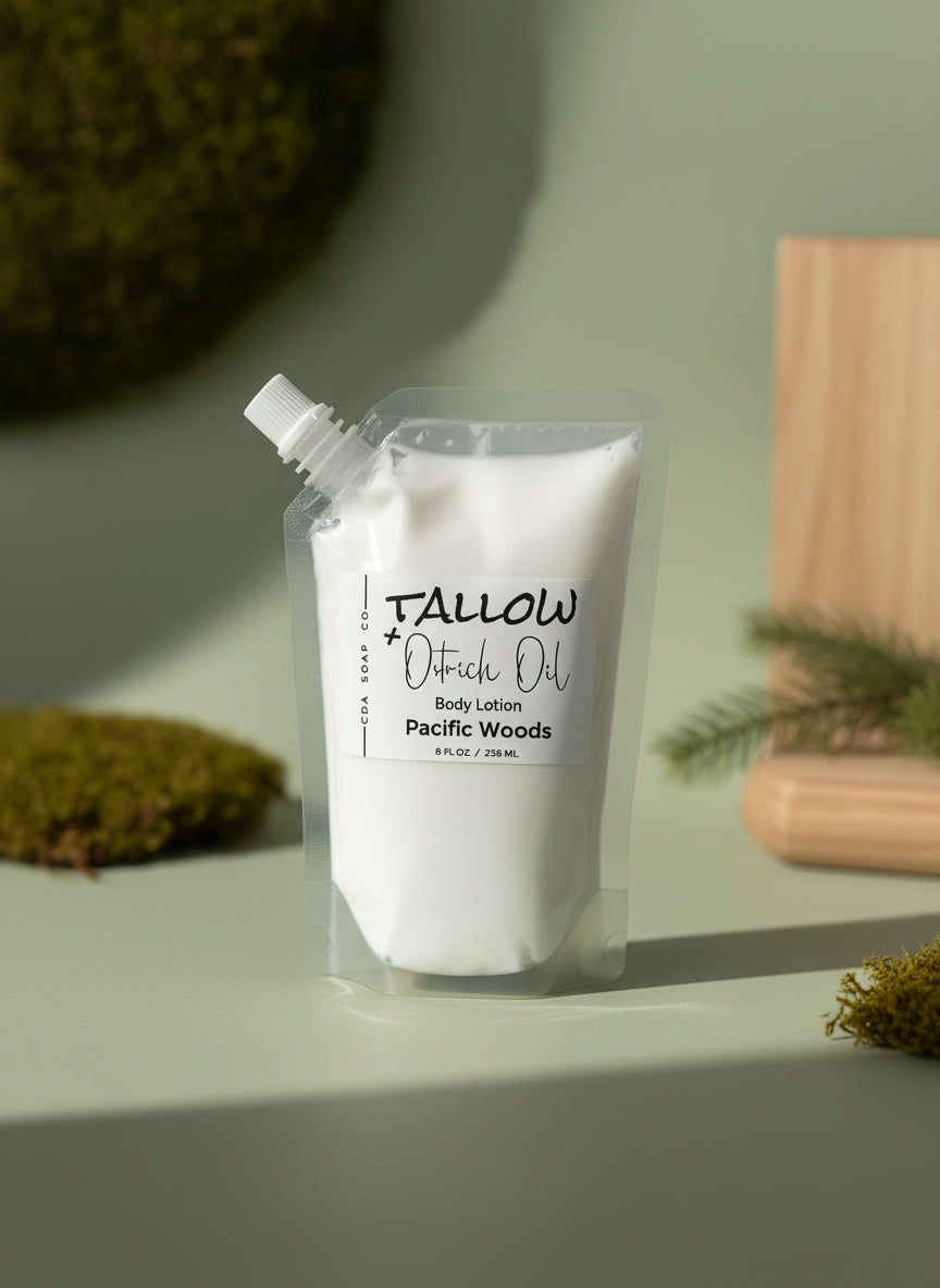 White body lotion pouch labeled 'Tallow' on a light surface with greenery in the background