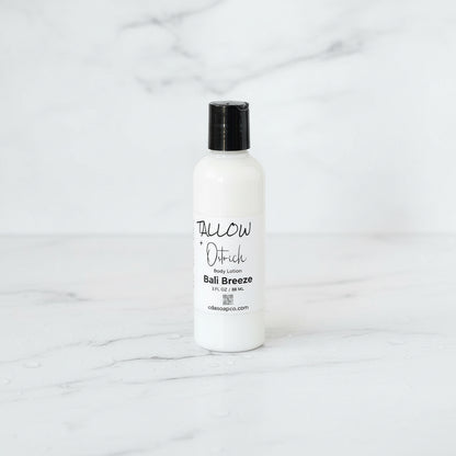 White lotion bottle with black cap on a marble surface