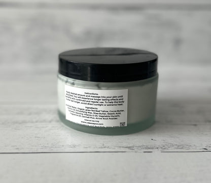 Jar of body butter with a black lid on a gray background