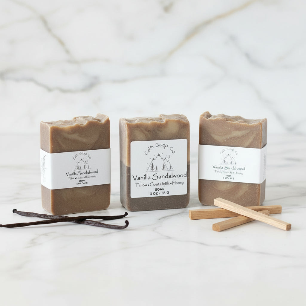 Three bars of Vanilla Sandalwood soap with labels on a marble surface.