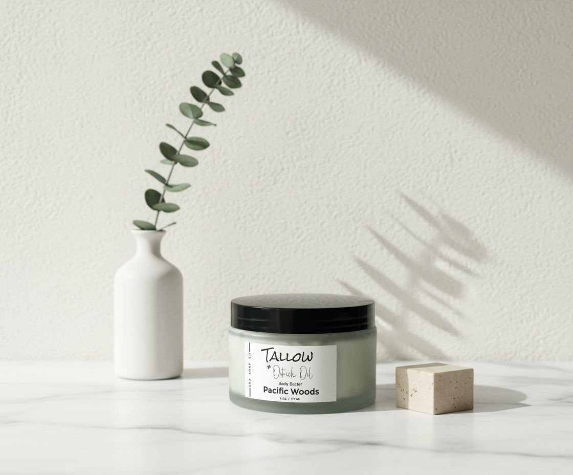 Jar of Tallow + Oat Milk Oil body butter labeled 'Pacific Woods' on a gray background
