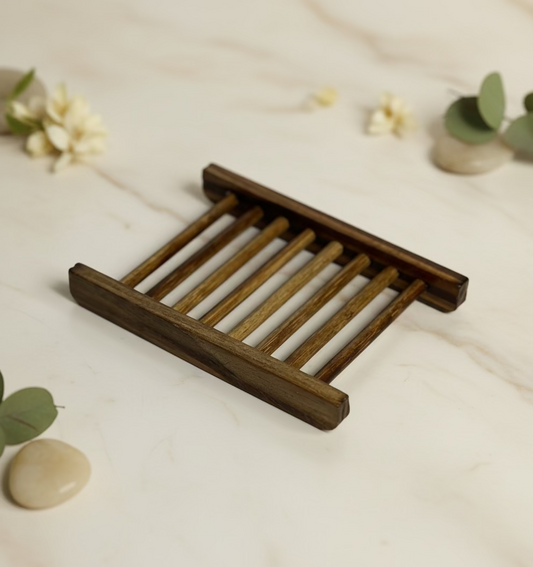 Wooden soap rack on a light surface with decorative elements