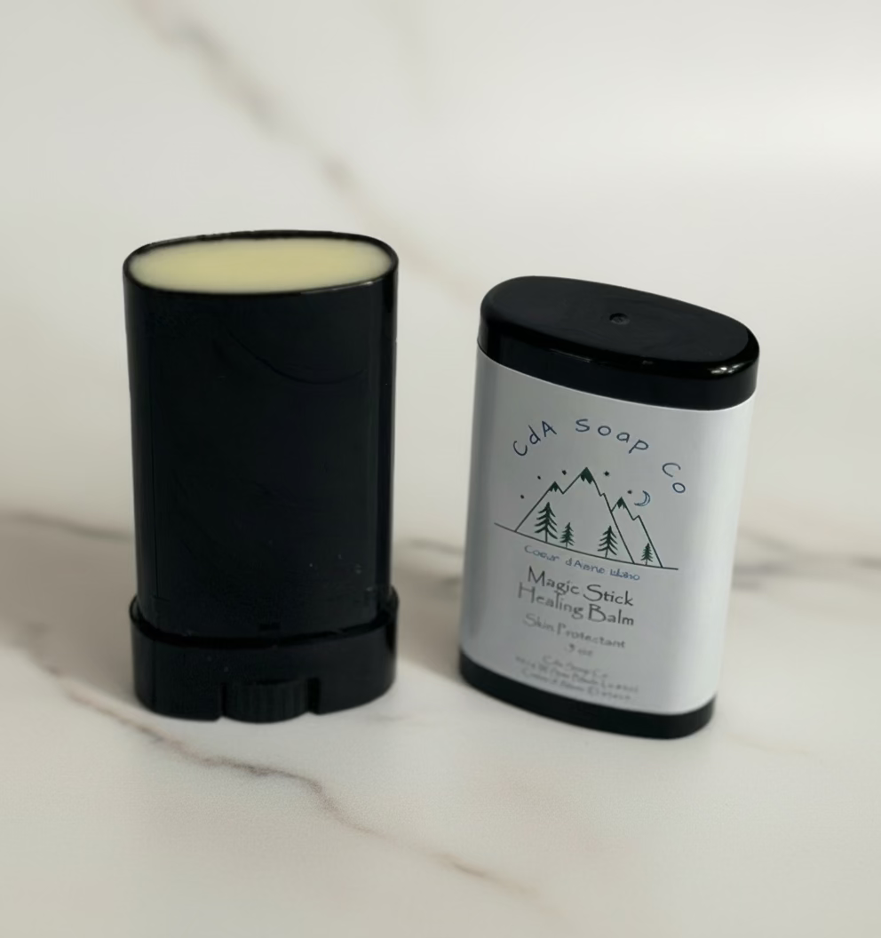 Black stick balm and container with 'CDA Soap Co' branding on a white background